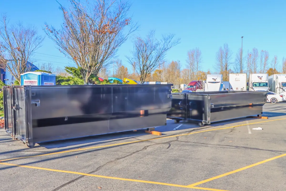 Professional dumpster rental service with roll-off container on residential driveway in Bellefontaine